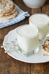 Two glasses of fresh yogurt on a wooden table
