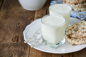 Two glasses of fresh yogurt on a wooden table