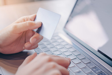Online payment,woman's hands holding credit card  and using computer for online shopping. Cyber Monday Concept.