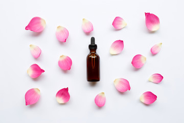 Obraz na płótnie Canvas Lotus essential oil with lotus petals on white background.
