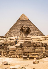Fototapeta na wymiar Egyptian Great Sphinx full body portrait head,with pyramids of Giza background Egypt empty with nobody. copy space