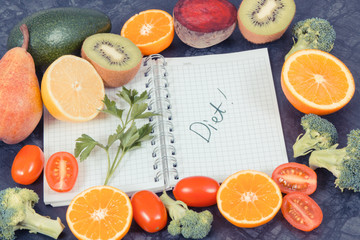 Natural fruits with vegetables as source vitamins and notepad with word diet, healthy nutrition concept