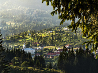 Sunset landscape in countryside. Lunca Ilvei village landscape view from up. Transylvania rural landscape in the mountains.