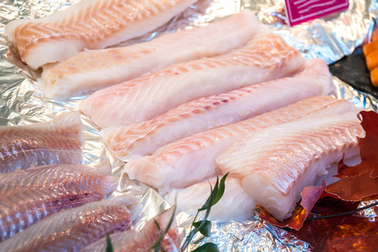 Fresh Chilled Out Fillets Of White Fish On The Counter Of Ice