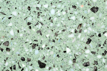 Close up of terrazzo flooring background texture with green base and marble and stone chips