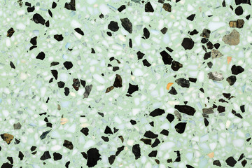 Close up of terrazzo flooring background texture with green base and marble and stone chips