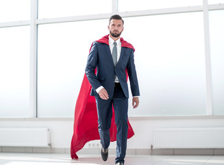 Businessman in a red superhero cloak.