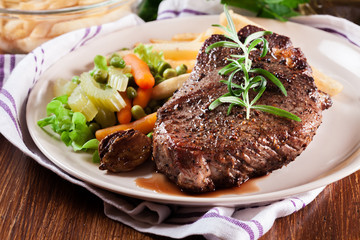 Beef steak served with baked potatoes