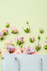 Flower arranging concept. Assorted fresh roses on green background. Flat lay.