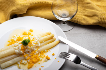 cooked white asparagus with butter and boiled eggs