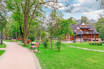 ZAKOPANE, POLAND - AUGUST 12, 2016: Old wooden architecture in city park © agneskantaruk
