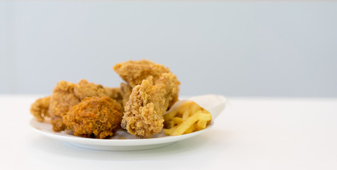 close up on fired chicken lunch set on plate for eating food concept