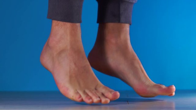 Close up slow motion shot of legs sports bare feet jump