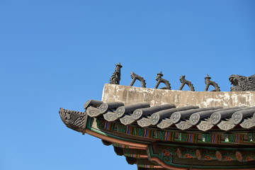Traditional korean roof decoration. blue sky and Colorful structures