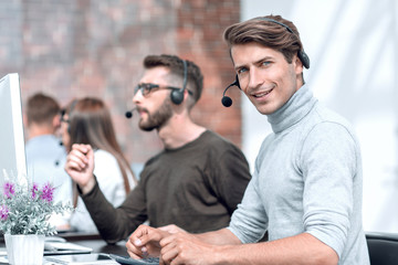 call center operator sitting at his Desk.
