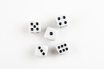 Pile of white with black dots dice on a white background