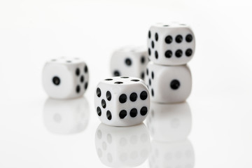 Pile of white with black dots dice on a white background