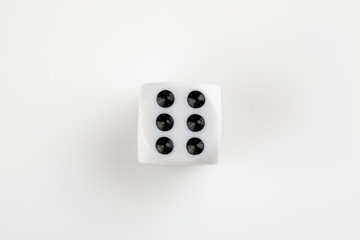 Single white with black dots dice on a white background, showing number six