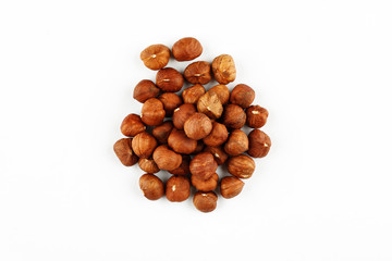 Pile of raw hazelnut on a white background
