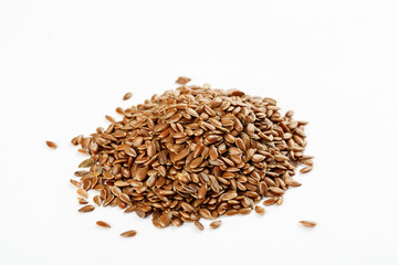 Pile of flax seeds on a white background