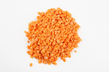 Pile of red lentils on a white background