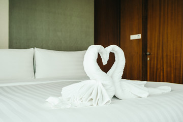 Honeymoon bed with swan towel with heart decoration © siraphol