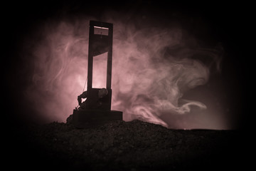 Horror view of Guillotine. Close-up of a guillotine on a dark foggy background.