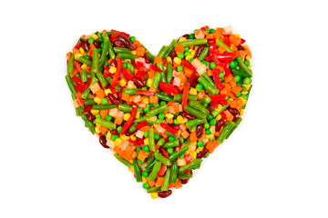 Heart made of vegetables. Corn, carrot, bell pepper, green beans. Isolated on white.