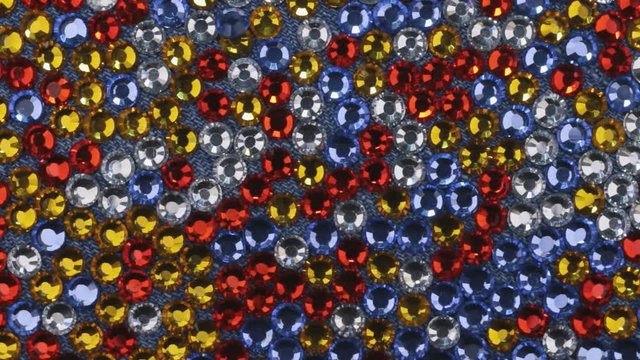 Rotation of multi-colored rhinestones as a background, texture.