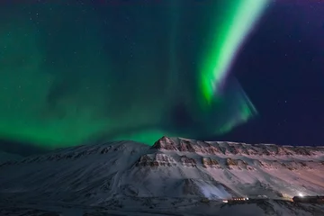 Fotobehang The polar arctic Northern lights aurora borealis sky star in Norway travel Svalbard in Longyearbyen city the moon mountains © bublik_polina