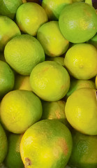 Fresh ripe limes as background, lime citrus fruit close up