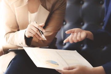 sales manager discussing with partner about spreadsheets