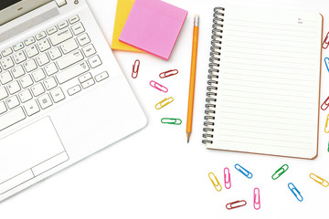 Top view workspace Notebook Computers, Multi-colored paper clip, sticky note, Notepad with yellow pencil placed On the office desk Has space for text Creative office style concept