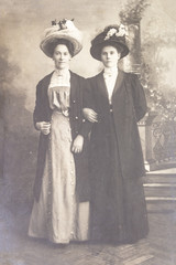 RUSSIA - CIRCA 1905-1910: Full body shot of two young women in studio, Vintage Carte de Viste...
