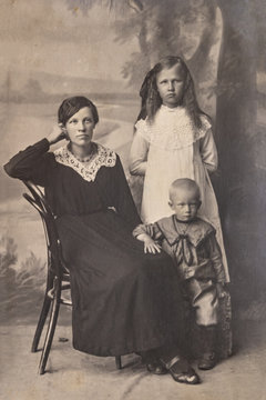 RUSSIA - CIRCA 1905-1910: A portrait of young woman with children in studio, Vintage Carte de Viste Edwardian era photo
