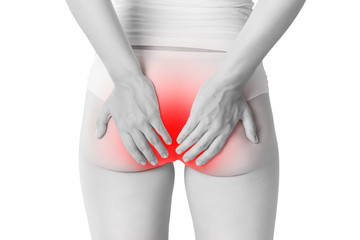 Woman suffering from hemorrhoids, anal pain isolated on white background