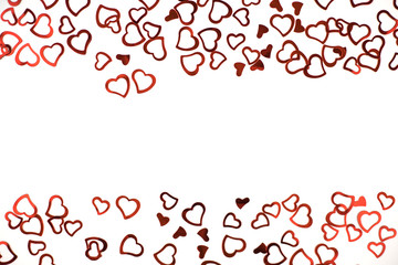 Little red confetti hearts on white background.