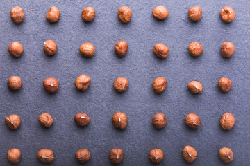Hazelnuts pattern on grey background