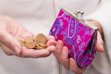 hand with coins saving on wallet