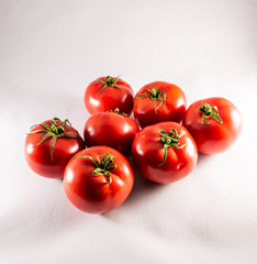 Red ripe tomatoes on white background