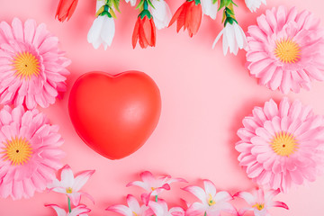 Red heart and flower on pink background