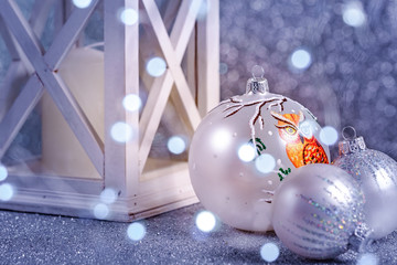 White Christmas balls on a blue background with bokeh