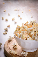 Salt popcorn on the wooden table, selective focus