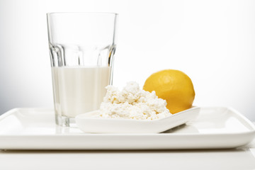 Dairy products, milk and sour-milk cottage cheese, cheese on a white background with a place for...