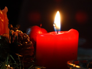 Red Candle Burning at Winter Night