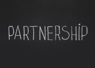 Partnership word written on chalkboard, copy space