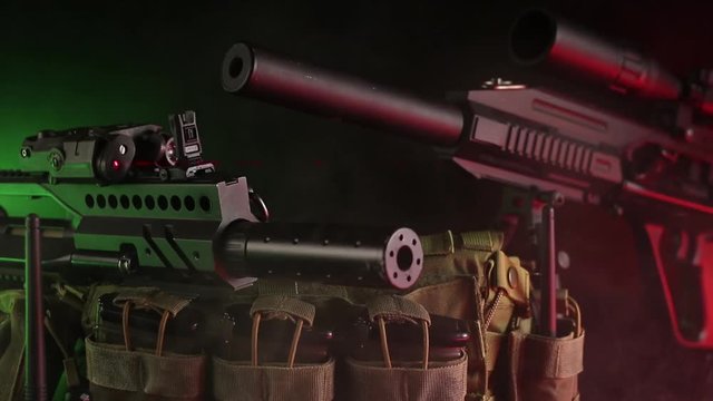 posting guns on the black background of haze and color controlam lighting