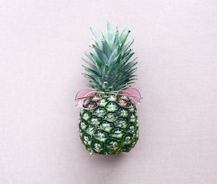 Pineapple wearing pink sunglasses.