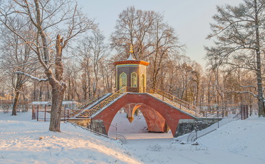 Cross bridge in the winter snow-covered Alexander Park in Tsarskoye Selo (Pushkin) in St. Petersburg