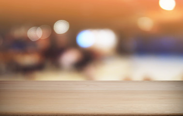 Empty dark wooden table in front of abstract blurred bokeh background of restaurant . can be used for display or montage your products.Mock up for space.
